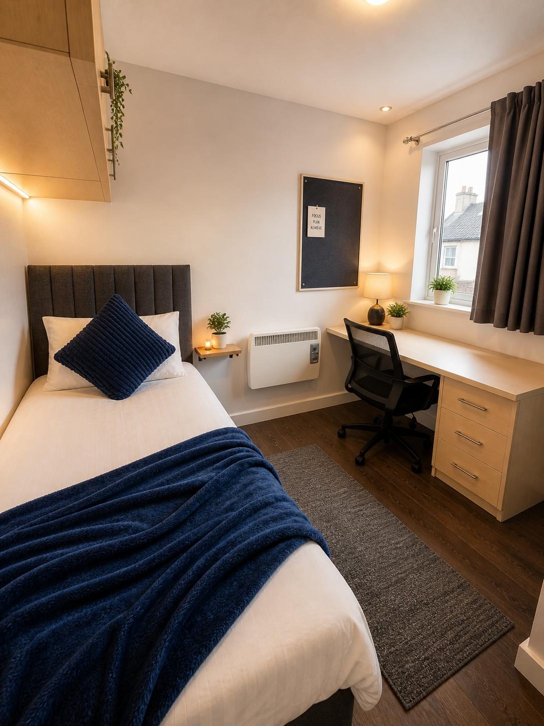 Finished bedroom with desk and navy bedding
